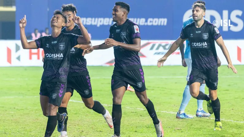 Odisha players celebrate after scoring a goal.