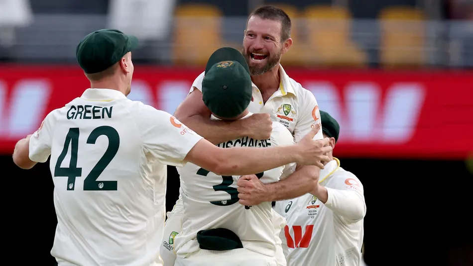 Michael Neser celebrates a dismissal with teammates in the pink-ball Test against England in Brisbane.