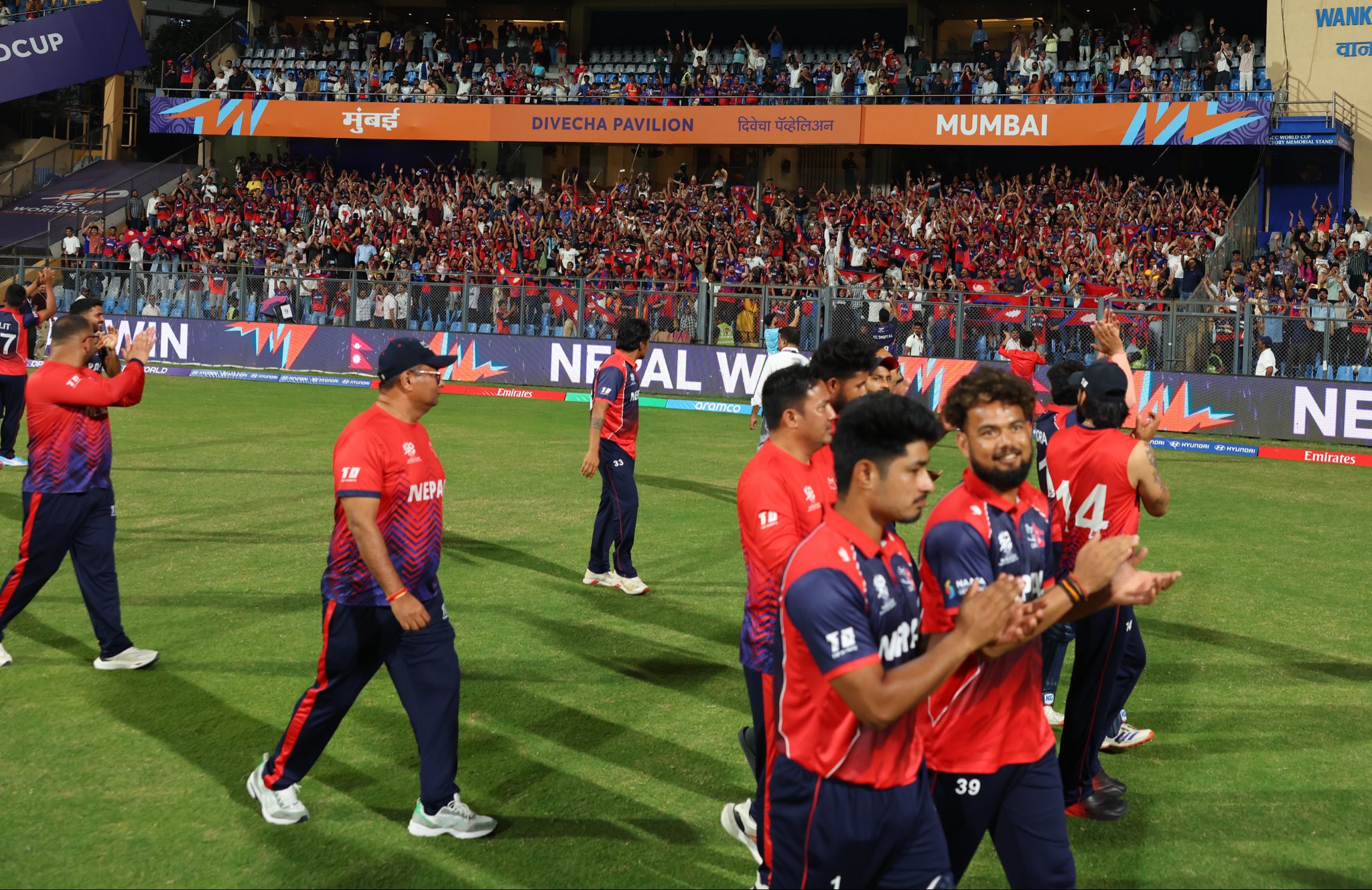 The Nepal cricket team acknowledge the crowd after their seven-wicket win over Scotland in their final T20 World Cup 2026 match in Mumbai.